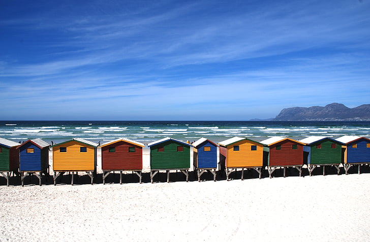 assorted-color of houses on seashore near island during daytime