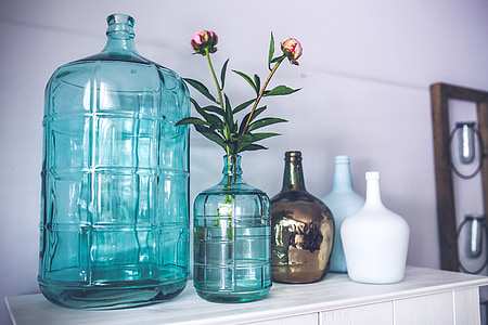 five assorted-color glass vases