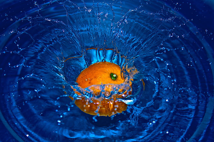 orange fruit drop on body of water