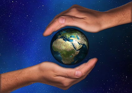 two human hands and planet earth