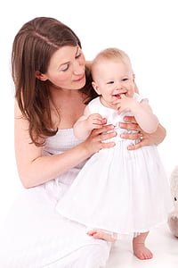 woman holding baby wearing dress