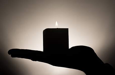person holding lighted candle