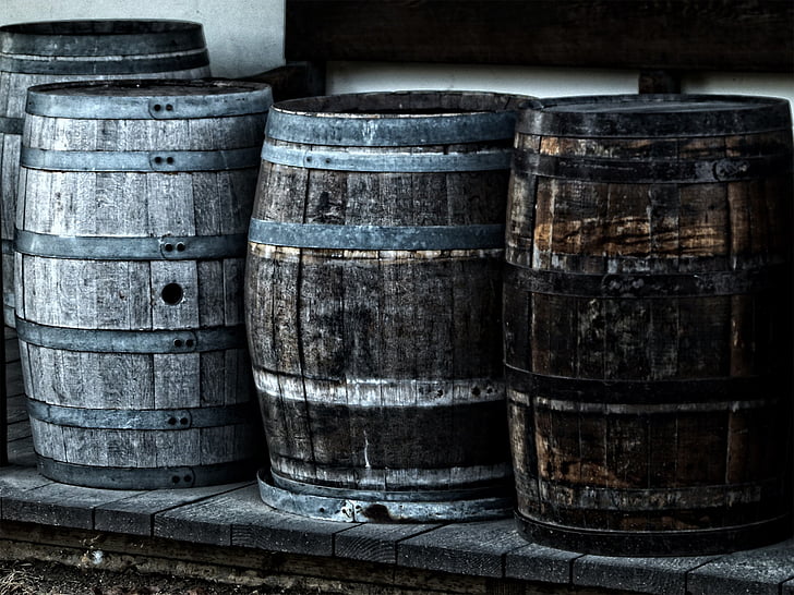 four gray wooden barrels