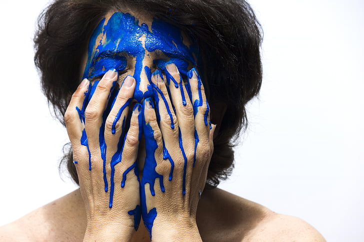 person make face blue paint