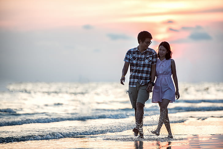 couple man and woman walking in seashore