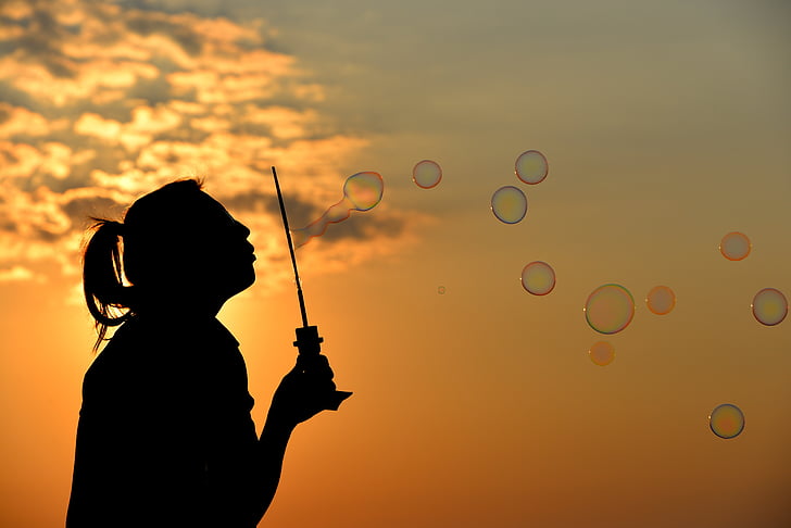 woman silhouette making bubbles