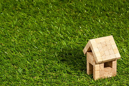 brown house miniature on green grass