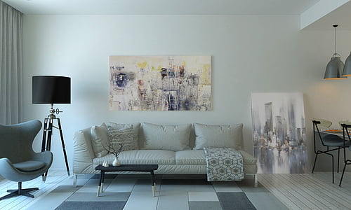 white leather sofa in front of painting on wall