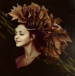 woman in black v-neck shirt and brown leaf headdress