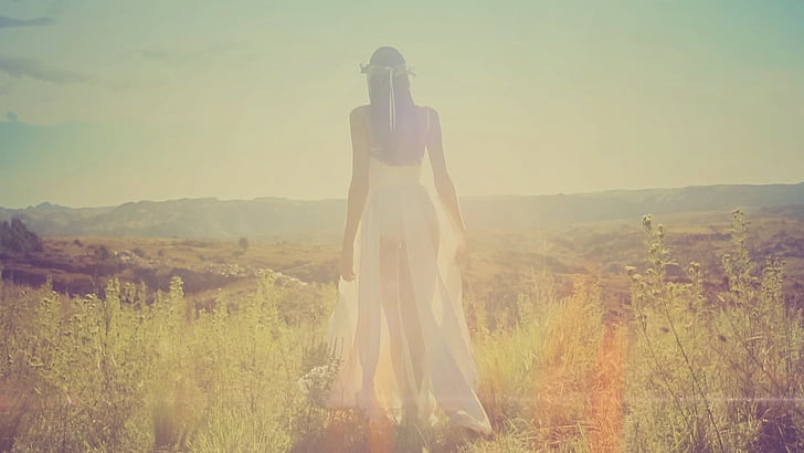 woman wearing white dress on grass field