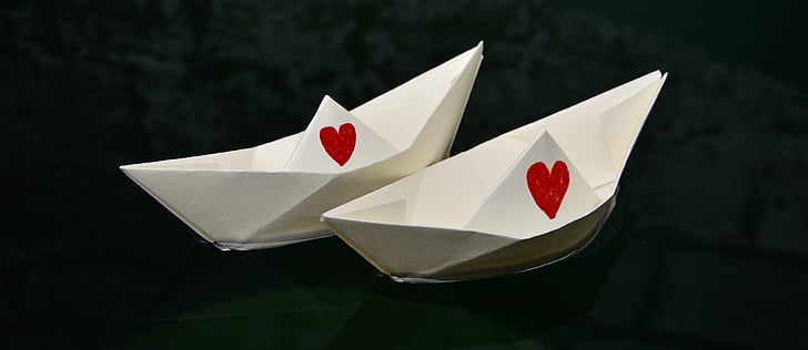 two white paper boats