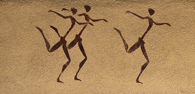 pyrography of three dancing humans