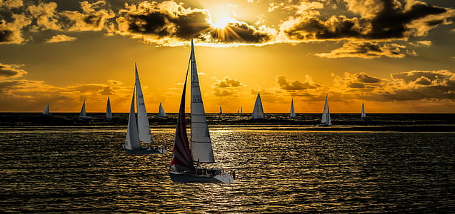 sailboats sailing on sea during sunset