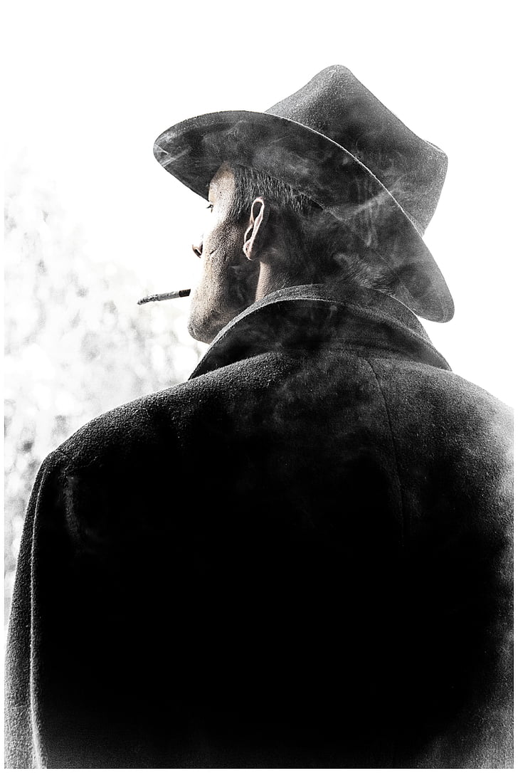 grayscale photography of man with black cowboy hat