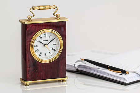 brown and gold table clock showing 10:10