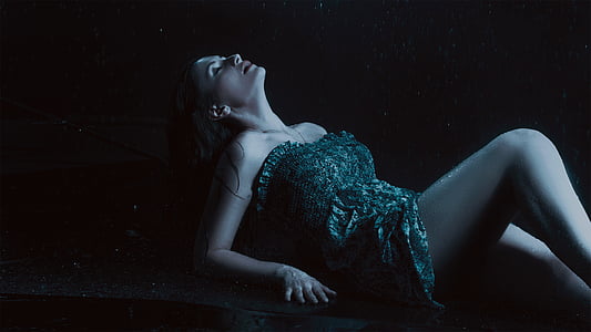 woman wearing gray tube dress while lying down