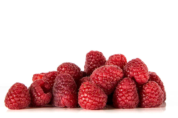 raspberries on white surface