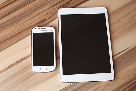 white Samsung Galaxy Android smartphone and white iPad