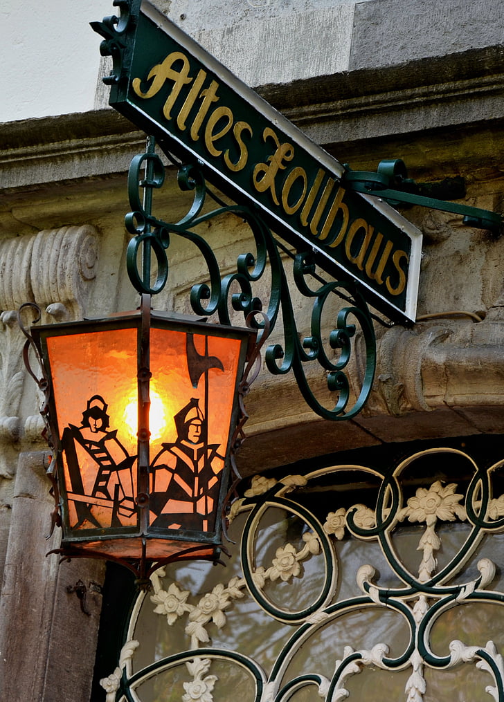 green and yellow steel Altes Lollhaus signage with hanging lamp