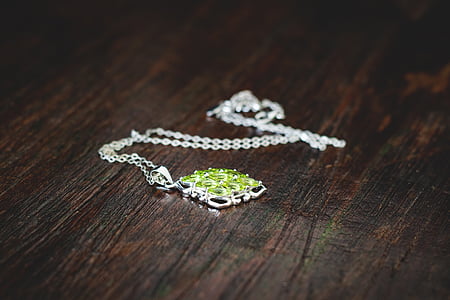 silver-colored green gemstone pendant necklace