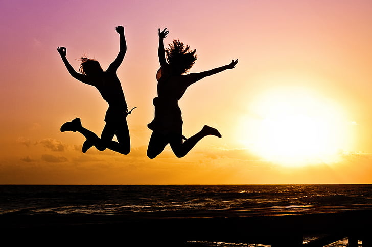 jump shot silhouette of two women during golden time
