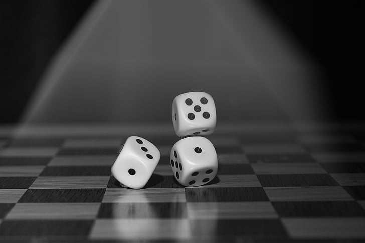 grayscale photo of three dices