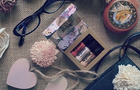 black framed eyeglasses beside cosmetic gift set box