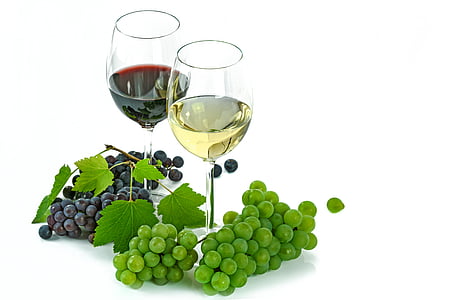 two wine glasses surrounded by grapes