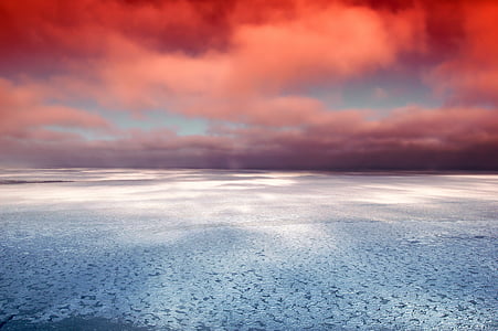 grey sand under red cloudy sky