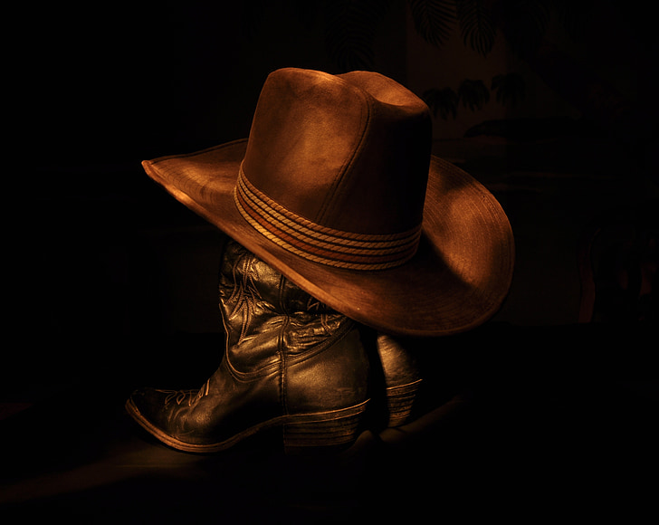 brown cowboy hat on black boots