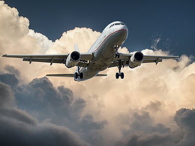 white passenger plane flying mid air during daytime