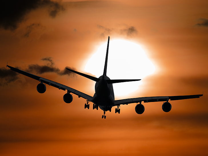silhouette photo of plane during golden hour
