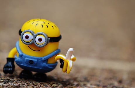 close-up photography of Minion holding banana plastic toy