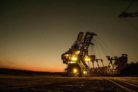 black and yellow industrial heavy equipment during sunset