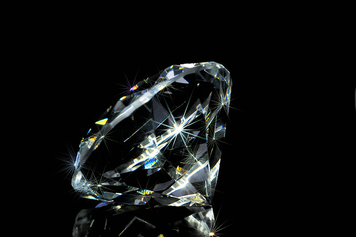photo of clear gemstone in black background
