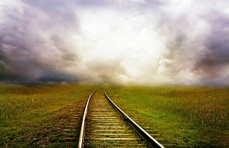 landscape photography of railway on green grass field