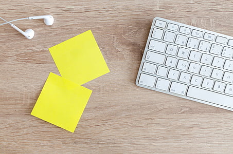 two yellow sticky notes near keyboard